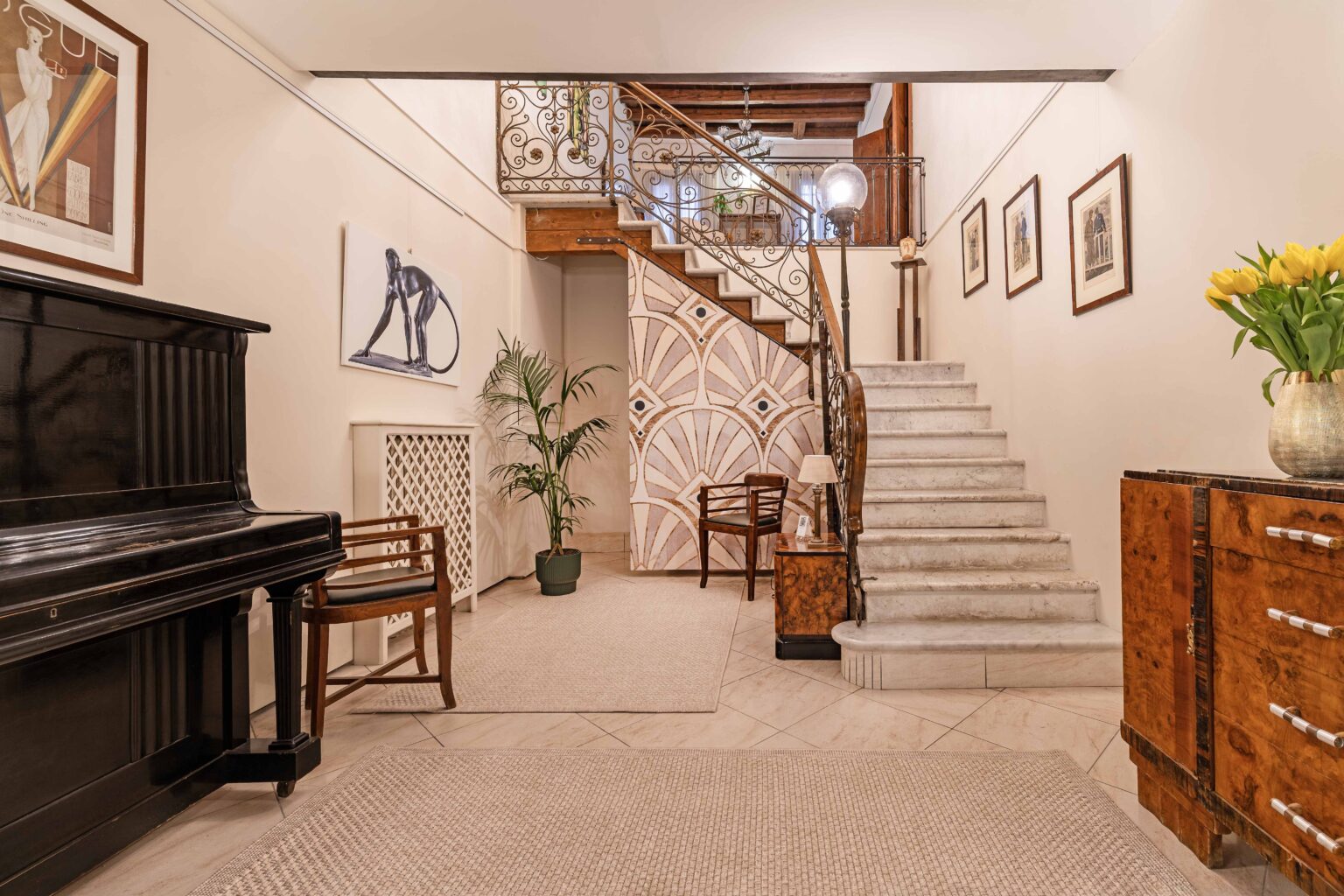 Entrance hall and historic staircase at Locanda Art Déco